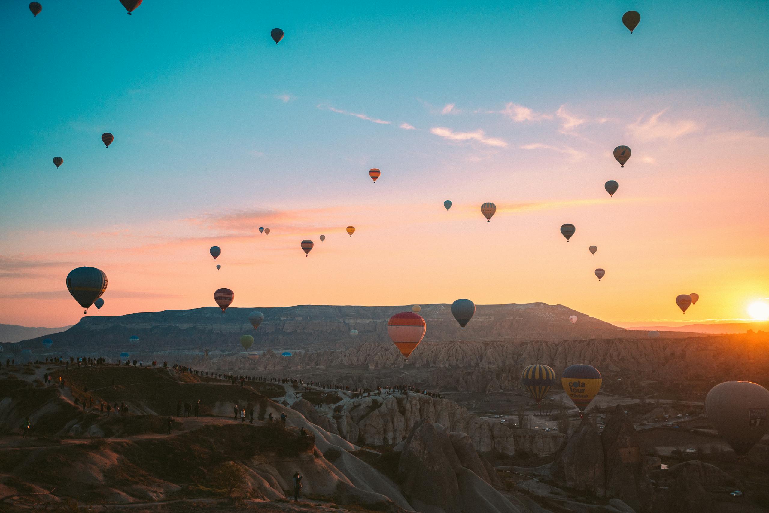 Colorful hot air balloons soaring over Cappadocia at sunrise, Turkey.